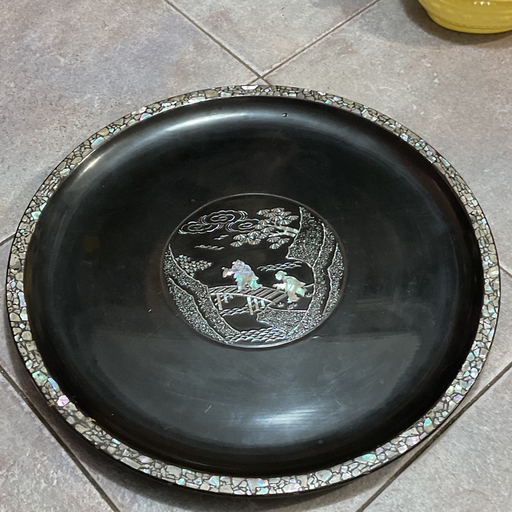 Black Decorative Plate with Inlay Design and black lather.
